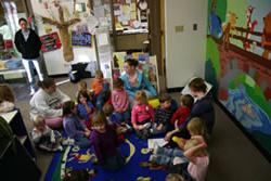 A group of children sit for an activity at the Child Development Center Laboratory